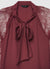 Blusa con fiocco e maniche in pizzo