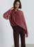Blusa con fiocco e maniche in pizzo