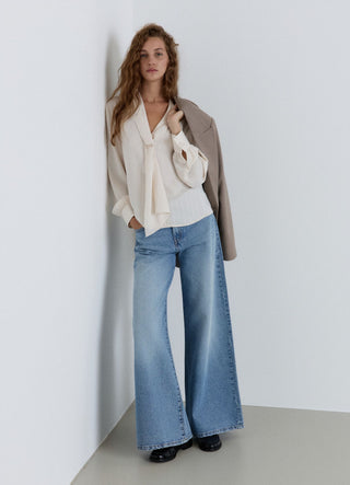 Blusa con rever sciallato a righe